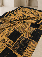Mustard and black newspaper print mulmul cotton saree, flat lay