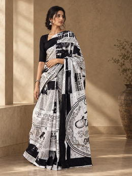 White newspaper print mulmul cotton saree with black border, worn by model
